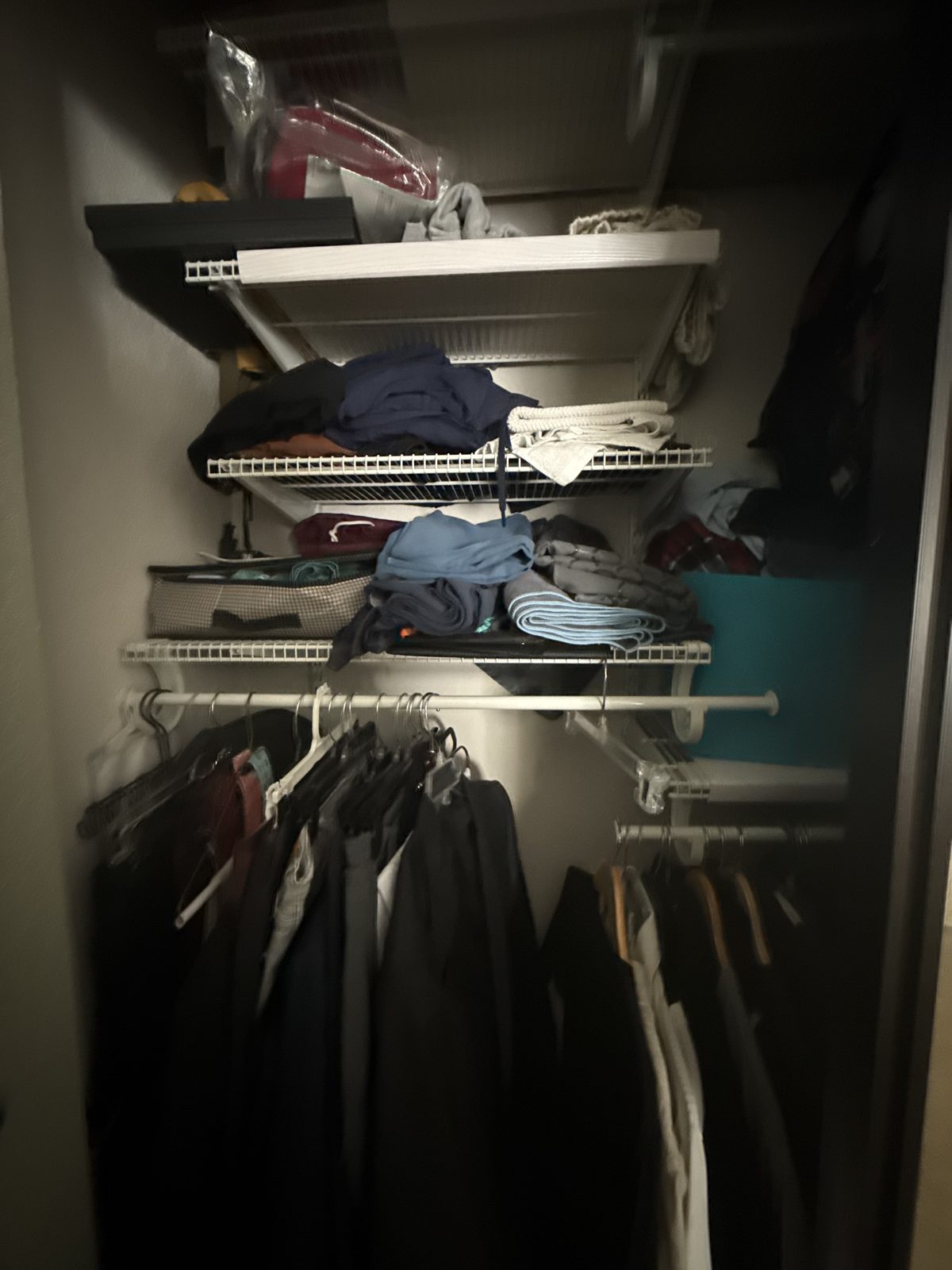 Closet before — folded clothes stacked loosely on wire shelves